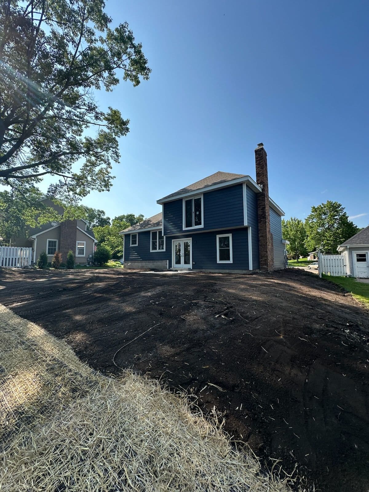 Yard Transformation with Fresh Soil and Straw Matting image